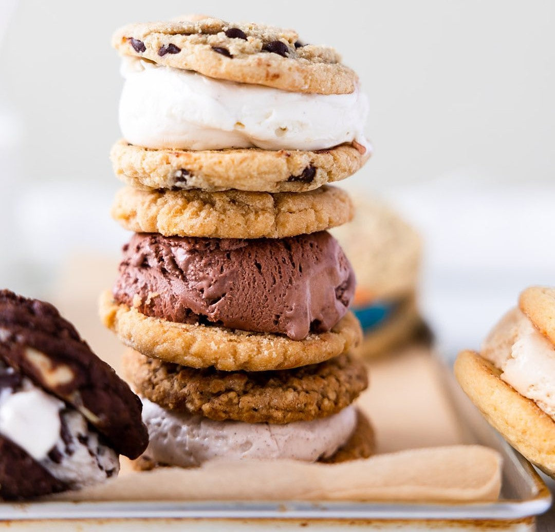 Stack of assorted Cool Jacks ice cream cookie sandwiches on a tray.