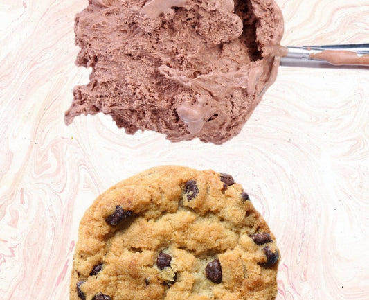 Chocolate chip cookie and scoop of chocolate ice cream from Cool Jacks on a marble background.
