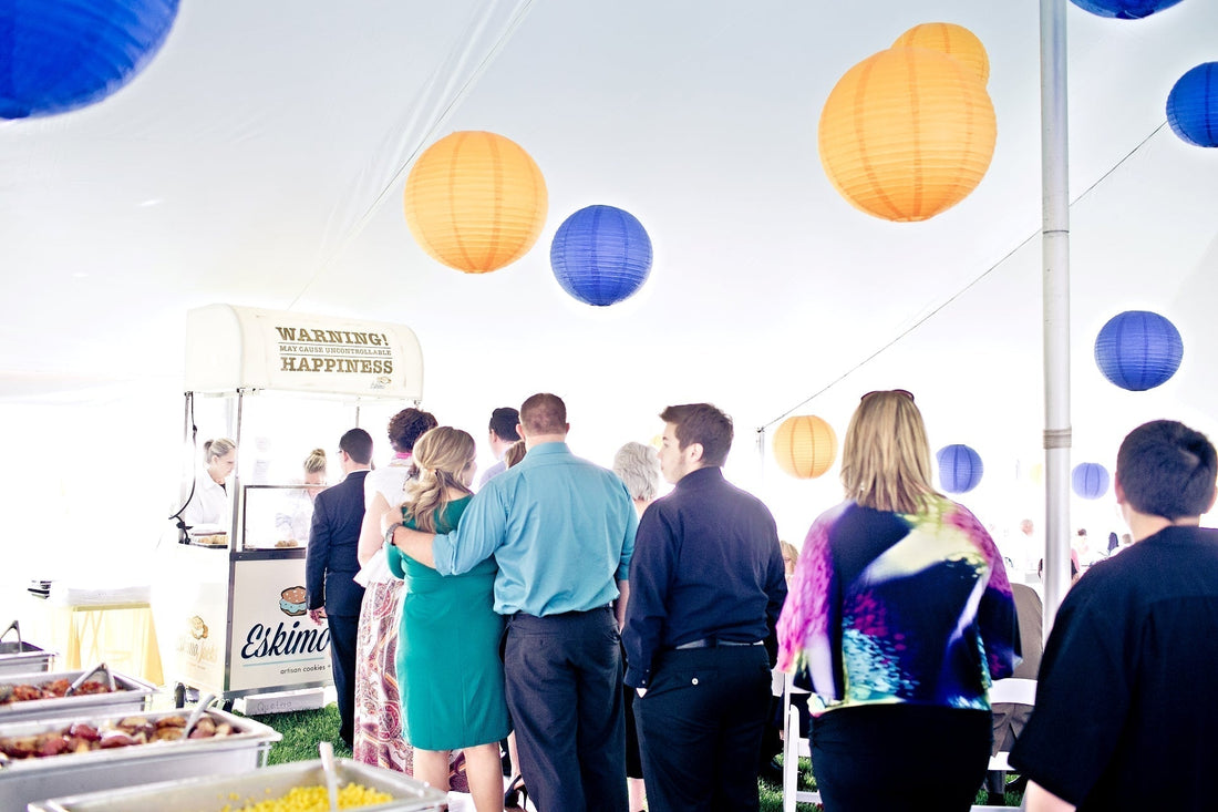 Guests queue at a colorful Cool Jacks ice cream sandwich cart enjoying summer in Michigan.