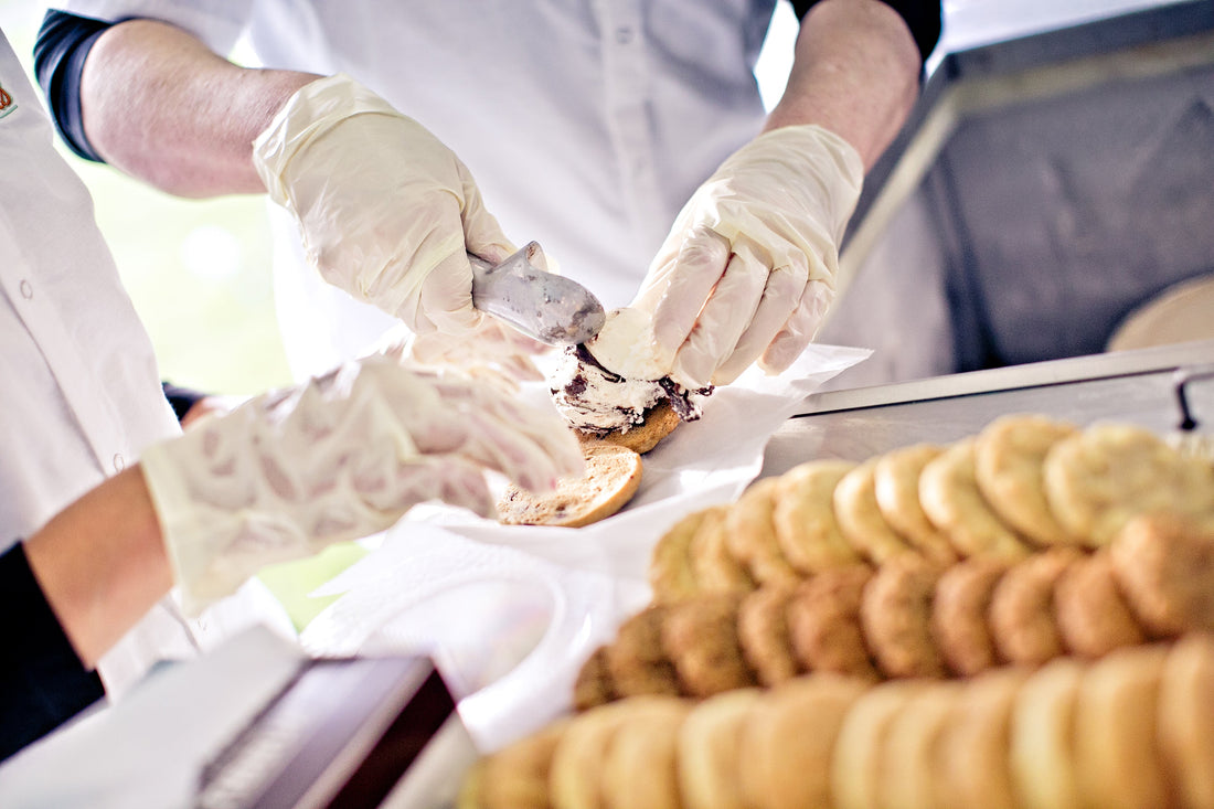 Cool Jacks staff assembling ice cream cookie sandwiches with fresh cookies and scoops.